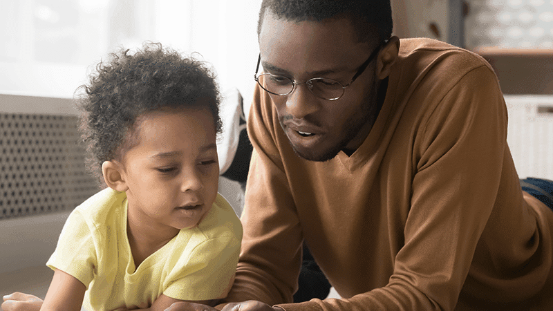 Boy and father reading